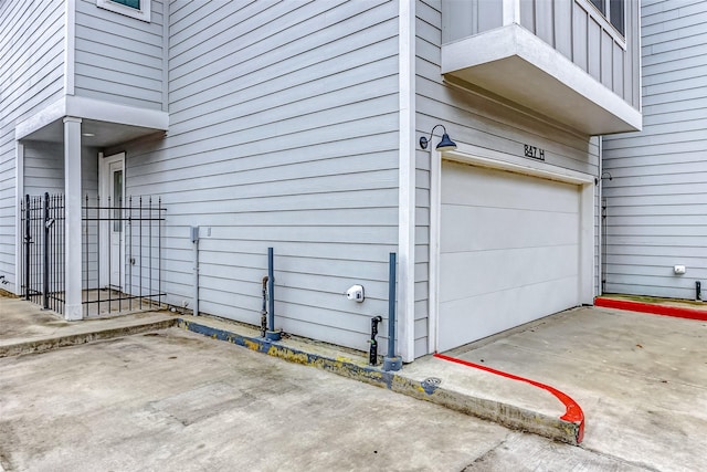 exterior space featuring a garage and a balcony