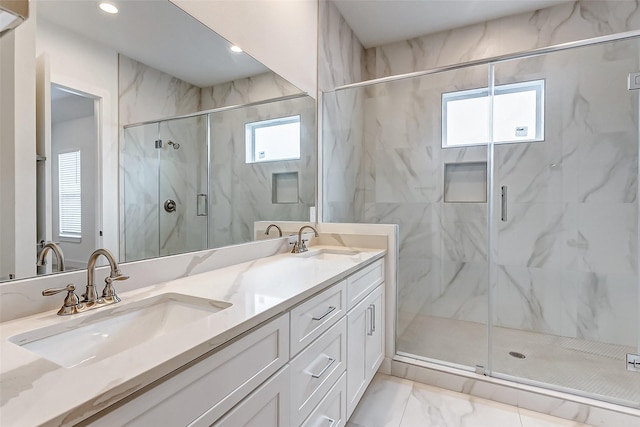 bathroom with vanity and a shower with shower door