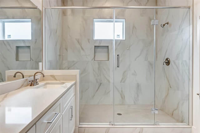 bathroom with vanity and a shower with shower door