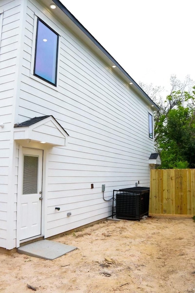 view of side of property with central AC unit