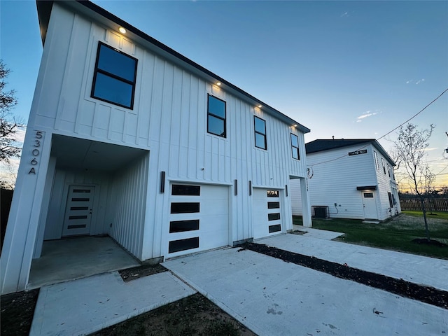 view of front of house featuring central AC unit and a garage