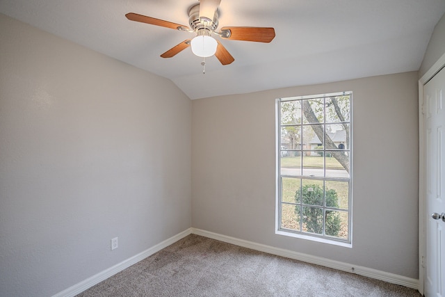 unfurnished room featuring ceiling fan, vaulted ceiling, and carpet floors