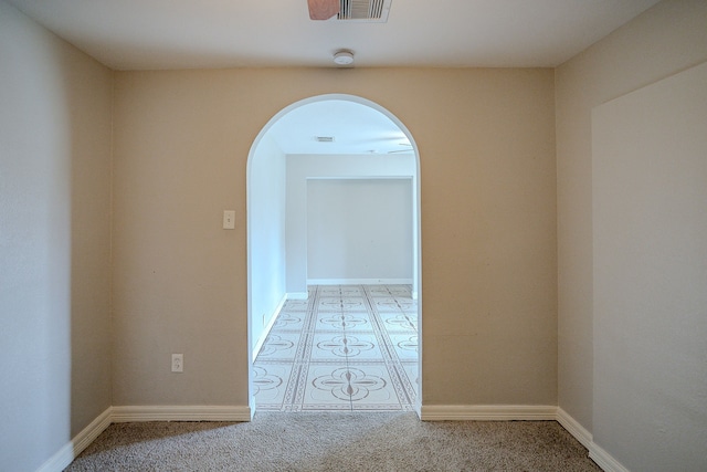 hall with light colored carpet