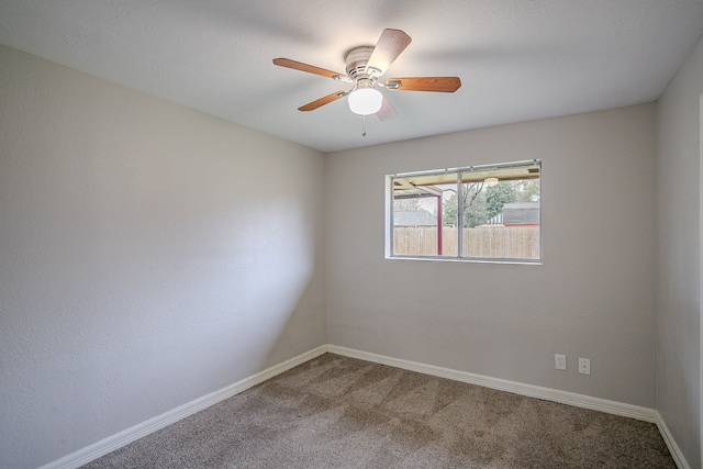 unfurnished room with ceiling fan and carpet flooring