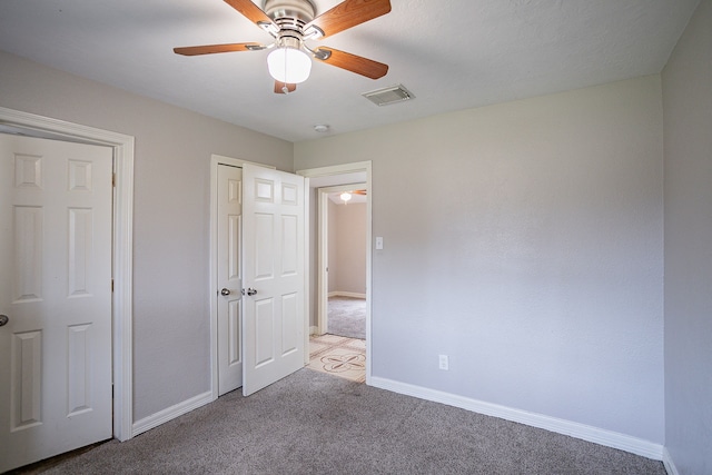 unfurnished bedroom featuring ceiling fan and light colored carpet