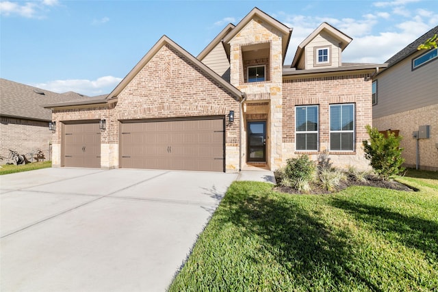 view of front of property featuring a front lawn and a garage