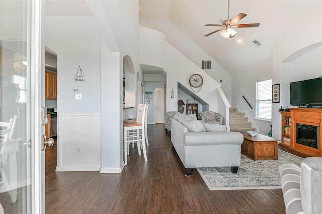 living room with lofted ceiling, ceiling fan, and dark hardwood / wood-style flooring