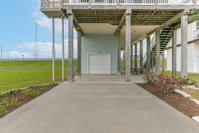 view of patio / terrace with a carport, a garage, and a water view