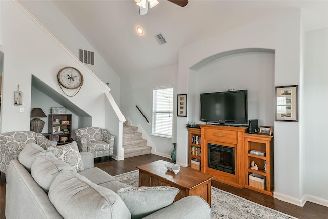 living room featuring ceiling fan, vaulted ceiling, and dark hardwood / wood-style floors