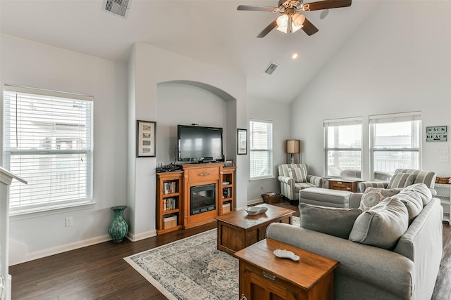 living room featuring high vaulted ceiling, ceiling fan, a healthy amount of sunlight, and dark hardwood / wood-style floors