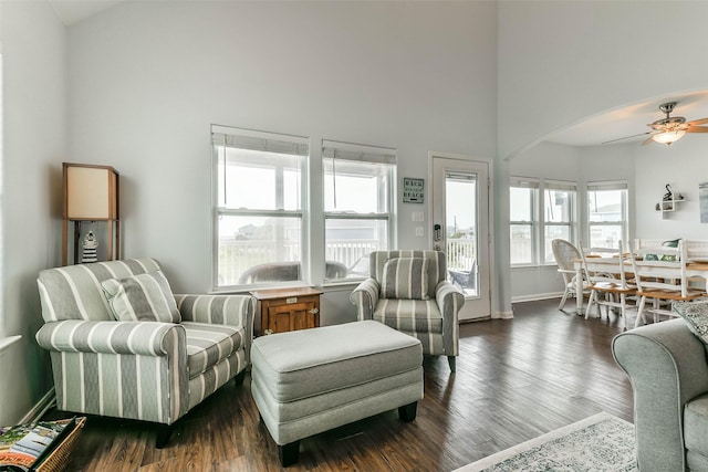 living room featuring dark hardwood / wood-style flooring and ceiling fan