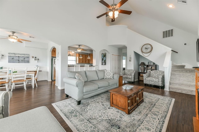 living room featuring high vaulted ceiling and dark hardwood / wood-style floors