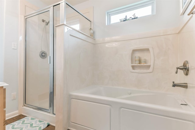 bathroom featuring hardwood / wood-style flooring and separate shower and tub