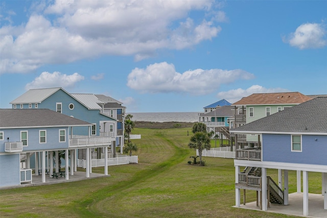 view of yard featuring a balcony, central air condition unit, a patio area, and a water view