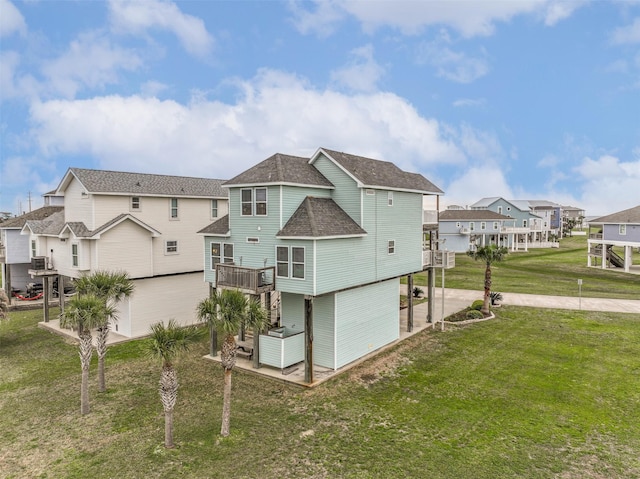 back of property featuring a lawn and a patio