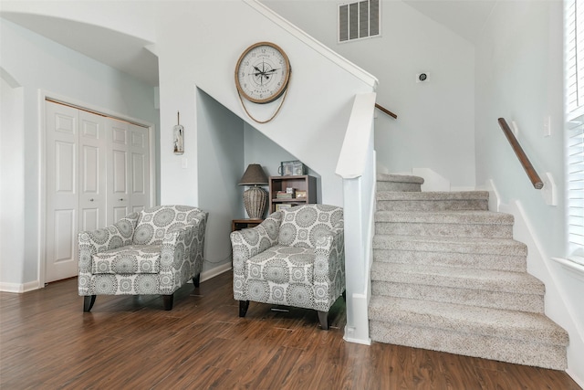 stairway with a wealth of natural light and wood-type flooring