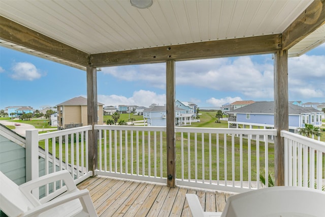 wooden deck with a lawn