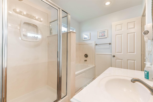 bathroom featuring separate shower and tub and vanity