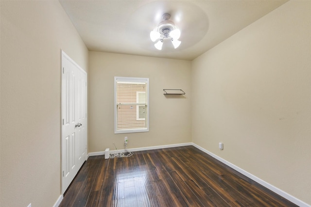 spare room featuring ceiling fan and dark hardwood / wood-style flooring