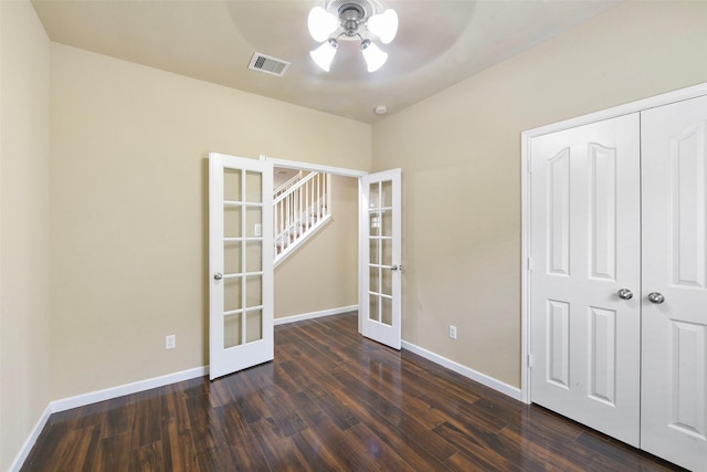 interior space featuring ceiling fan, french doors, a closet, and dark hardwood / wood-style floors