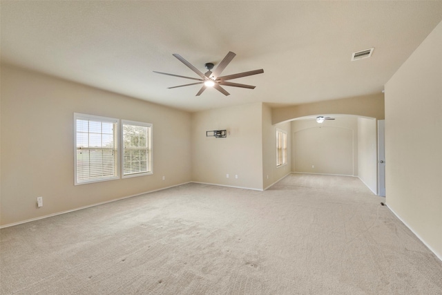 spare room featuring ceiling fan and light carpet