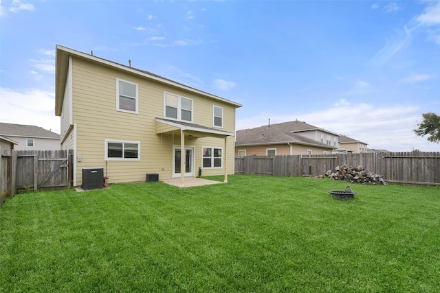 rear view of property with a lawn and central AC unit