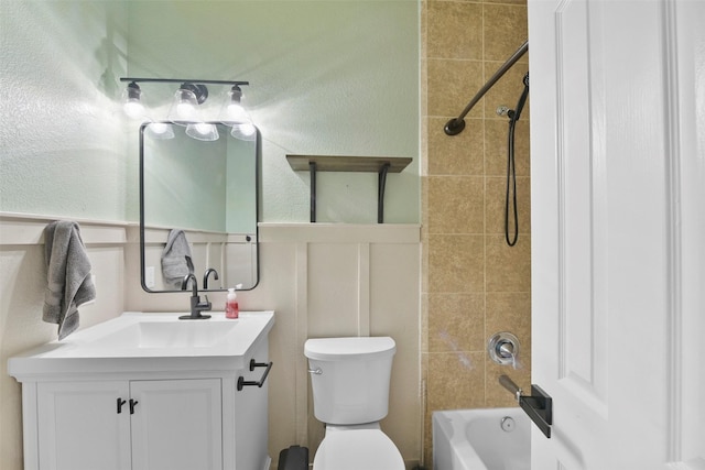 full bathroom with tiled shower / bath combo, vanity, and toilet