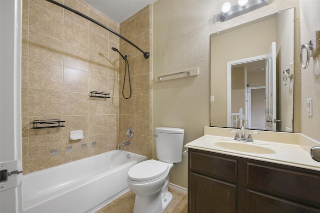 full bathroom with toilet, vanity, and tiled shower / bath