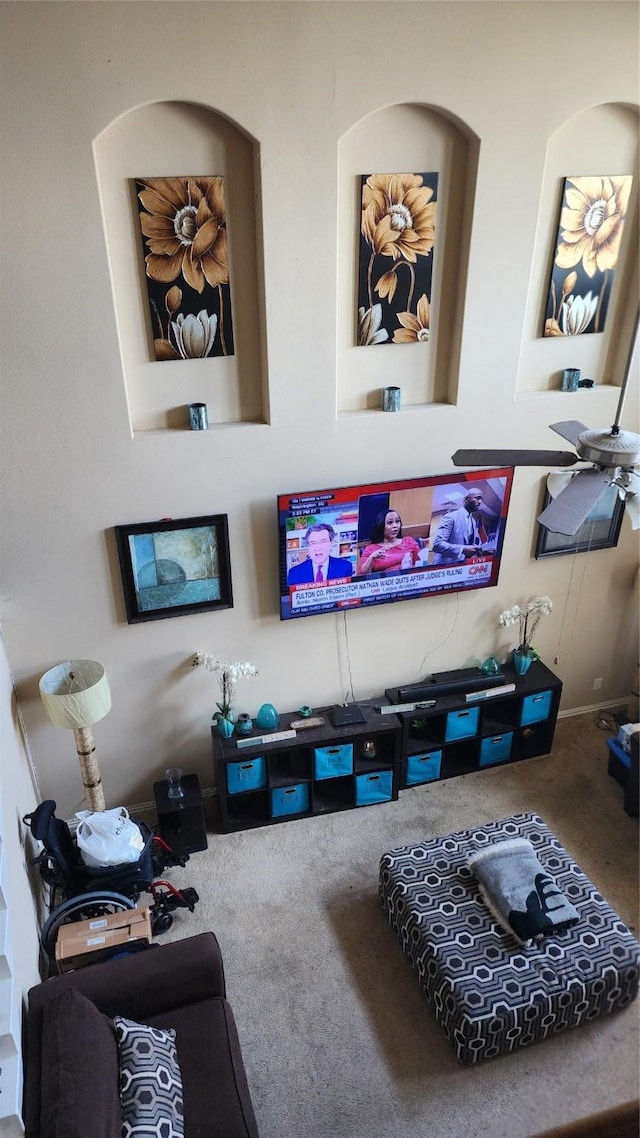 living room featuring ceiling fan and carpet flooring