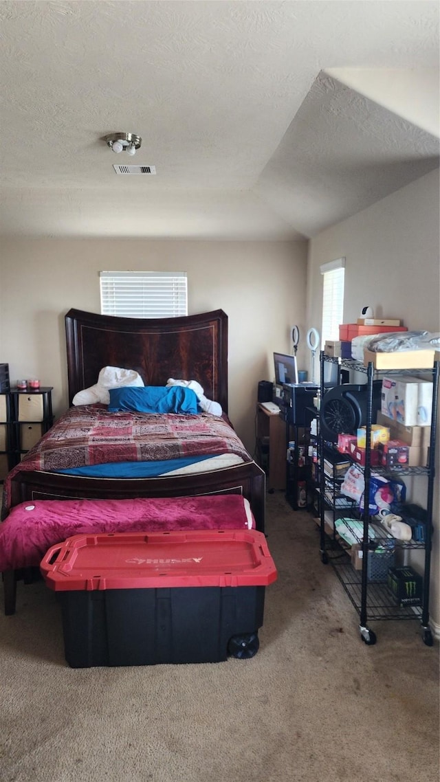 carpeted bedroom featuring a textured ceiling