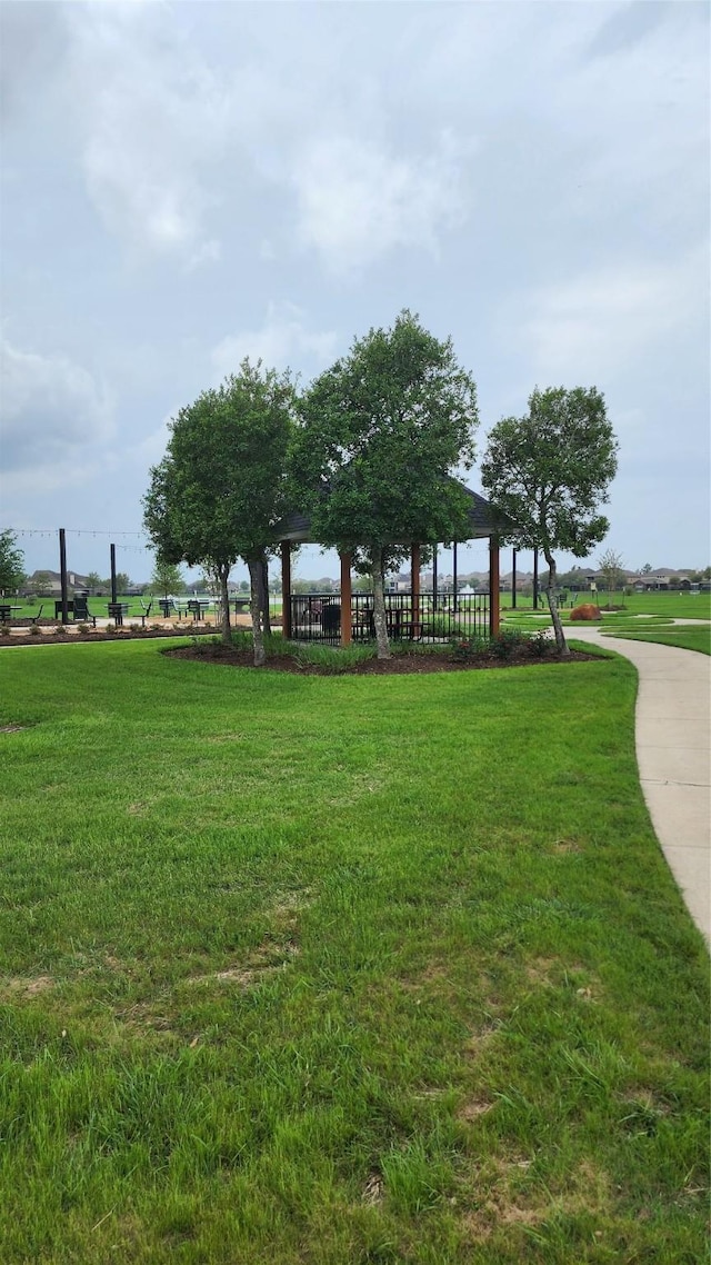 surrounding community with a gazebo and a yard