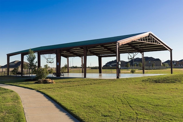 view of property's community featuring a yard and basketball court