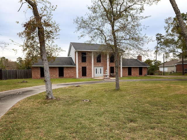 neoclassical home with a front yard