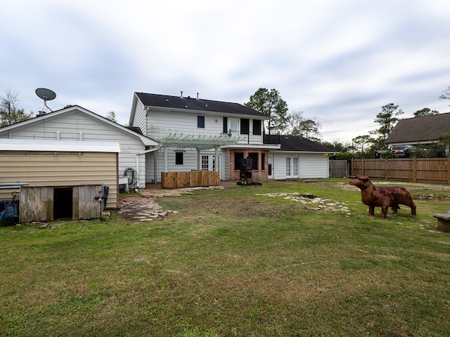 back of house with a lawn and a pergola