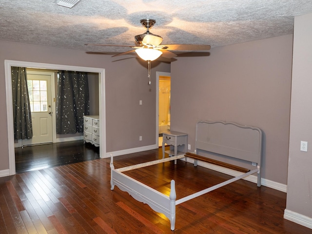 bedroom featuring a textured ceiling, ceiling fan, and dark hardwood / wood-style floors