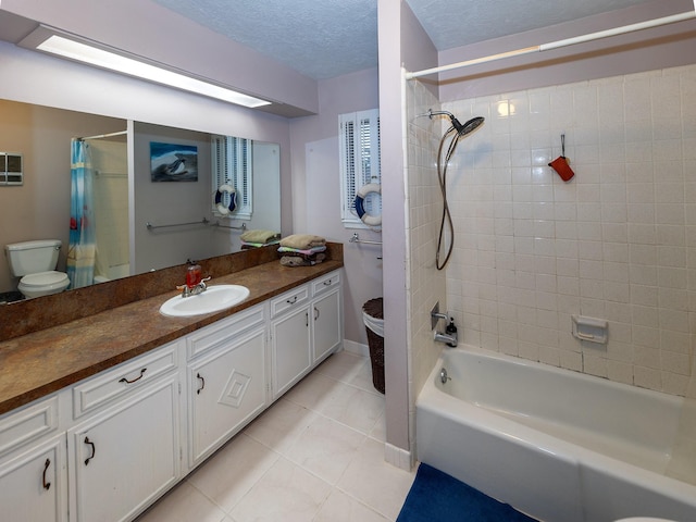 full bathroom featuring a textured ceiling, shower / bathtub combination with curtain, tile patterned flooring, toilet, and vanity