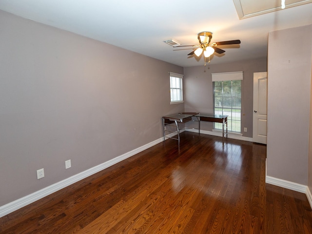 spare room featuring ceiling fan and dark wood-type flooring