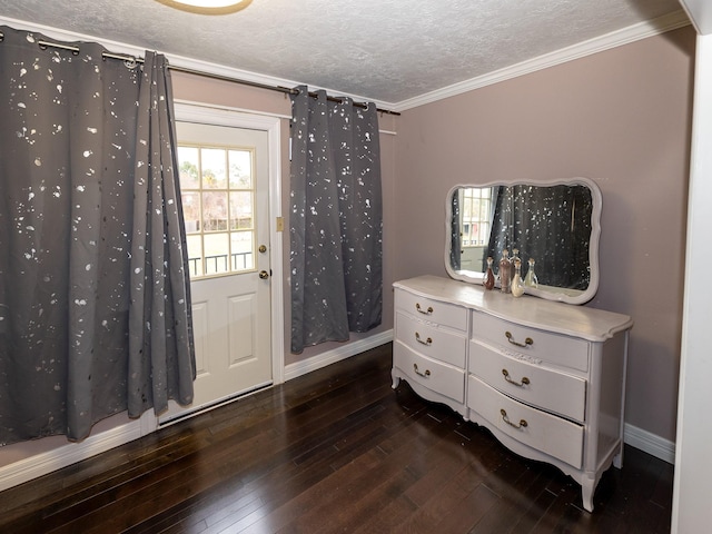 foyer entrance with a textured ceiling, ornamental molding, and dark hardwood / wood-style flooring