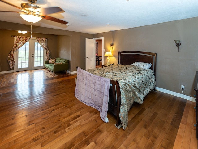 bedroom featuring dark hardwood / wood-style flooring, ceiling fan, french doors, and access to exterior