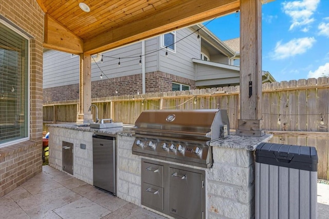 view of patio / terrace with sink, exterior kitchen, and area for grilling