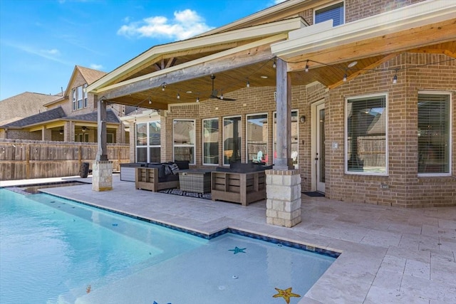 view of swimming pool featuring ceiling fan, a patio, and an outdoor living space