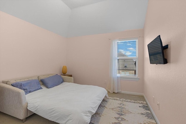 carpeted bedroom featuring lofted ceiling