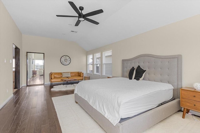 bedroom with lofted ceiling, hardwood / wood-style flooring, ceiling fan, and multiple windows