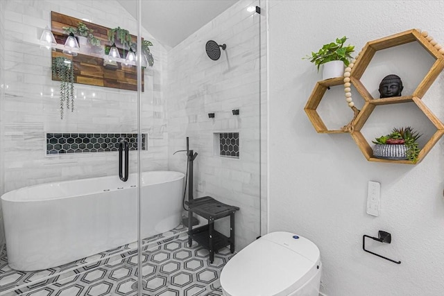 bathroom featuring toilet, tile patterned flooring, and a bath