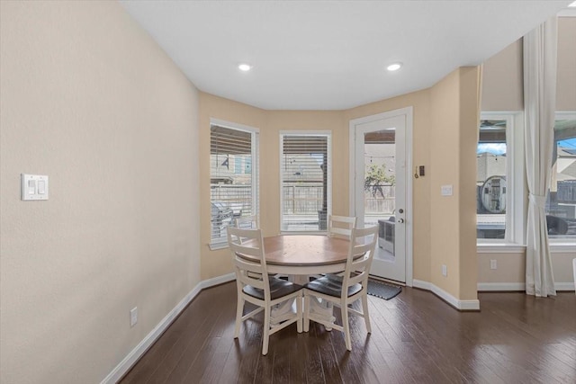 dining space with dark hardwood / wood-style floors