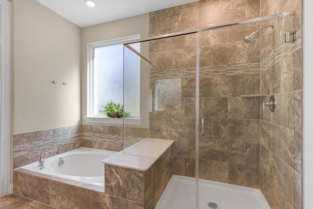 bathroom with separate shower and tub