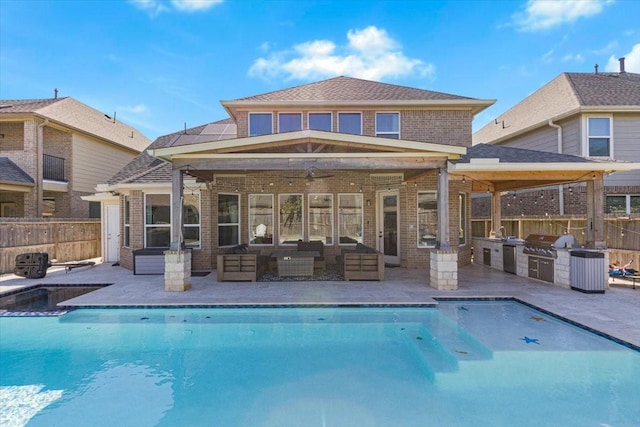 rear view of property with an outdoor kitchen, a patio area, ceiling fan, and an outdoor hangout area