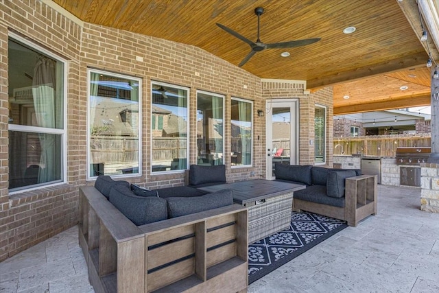 view of patio / terrace with area for grilling, exterior kitchen, ceiling fan, and an outdoor living space