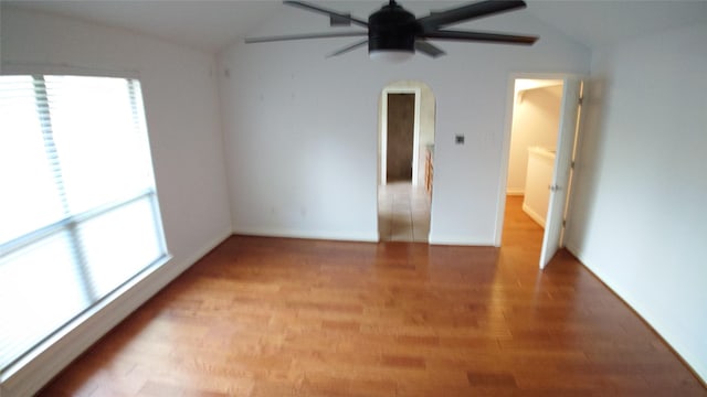 empty room with ceiling fan and lofted ceiling