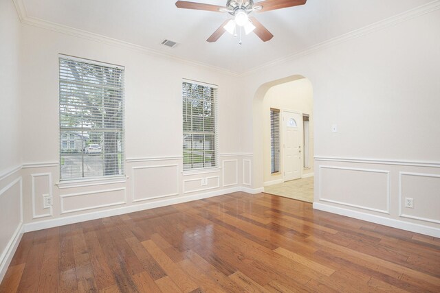 unfurnished room featuring ceiling fan, hardwood / wood-style flooring, and ornamental molding